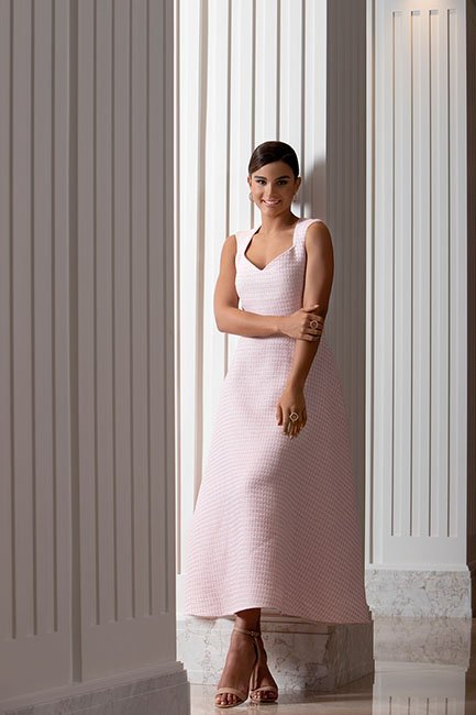 Clarissa Molina fotos revista hola wears a classic long pink dress with her hair tied back between white columns at the four seasons hotel in madrid.